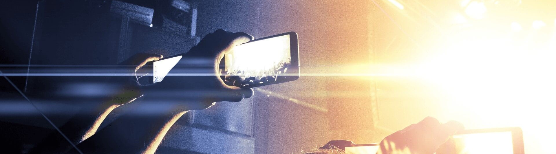 people recording video at concert with phones